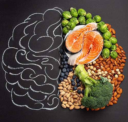 chalk drawing of human brain alongside healthy food